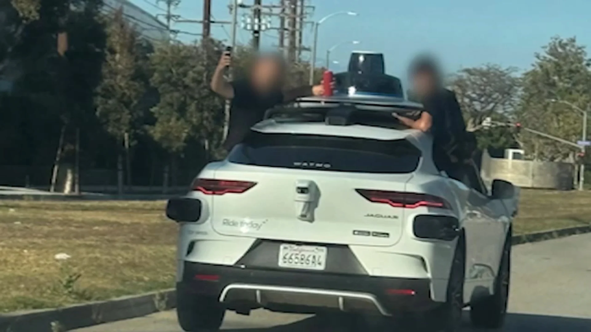 Teens seen hanging out of Waymo in busy Santa Monica traffic
