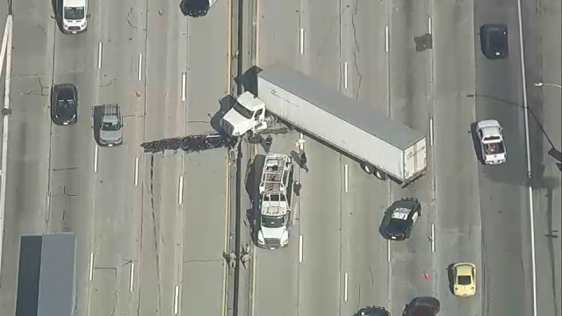 Jackknifed big rig blocks lanes on both sides of 210 Freeway in Azusa