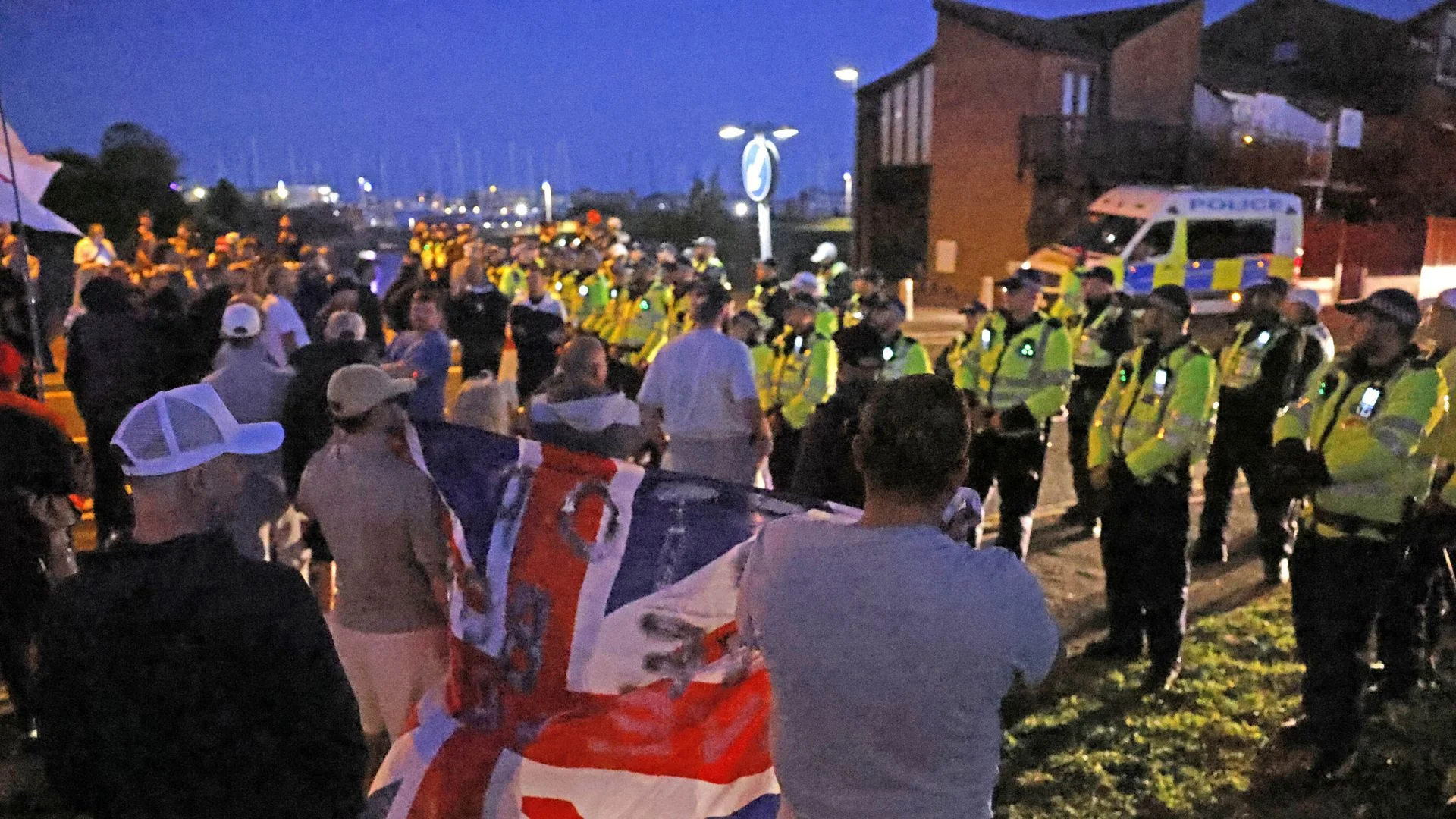 Anti-migrant protesters gather at seaside town as dinghy crosses Channel to UK