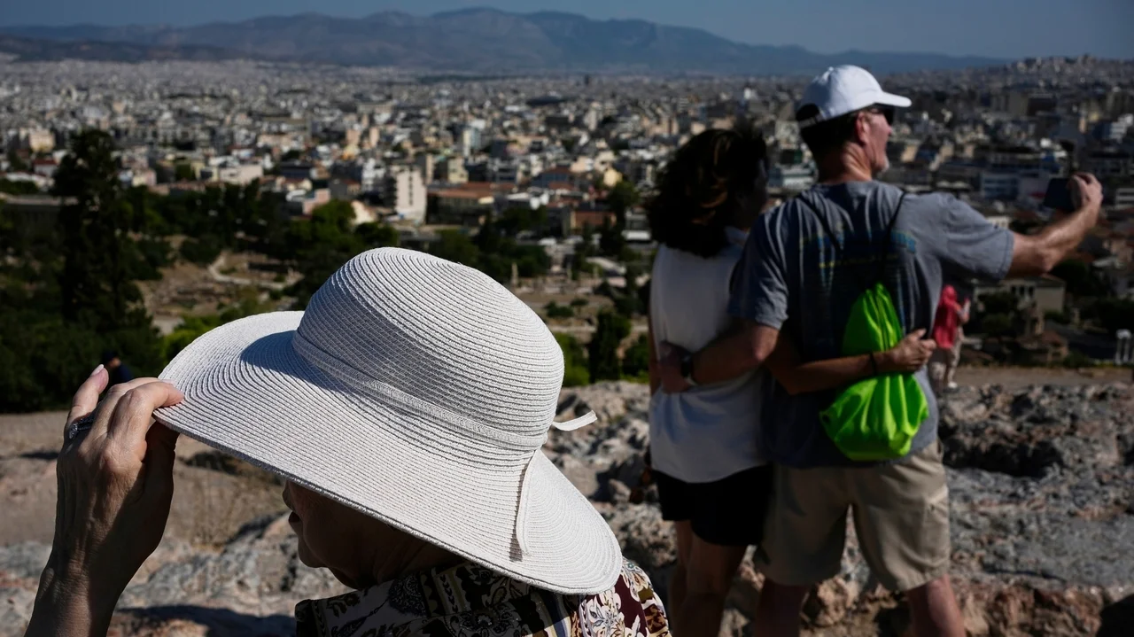 The sunhat is everywhere in Athens as crowds grow larger at ancient sites
