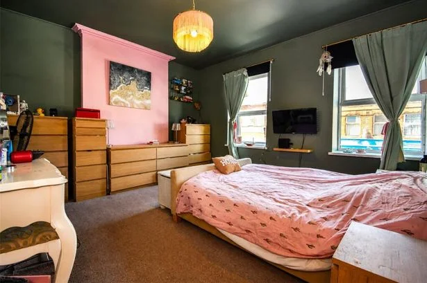 Birkenhead home's bright pink door gives a hint of what is behind it