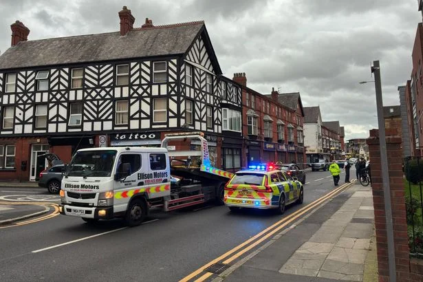 Man in hospital after Audi flips onto roof in Garston crash with parked vehicles